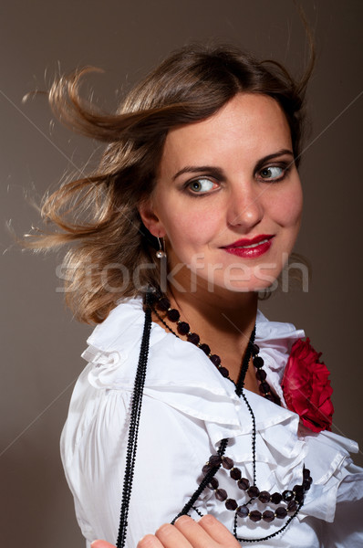 Kobieta biała bluzka czerwony kwiat włosy wiatr Zdjęcia stock © pekour