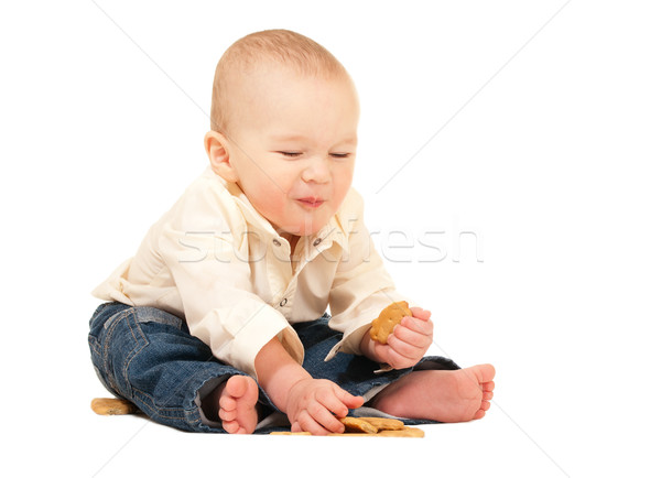 Happy laughing baby in jeans eating cracker Stock photo © pekour