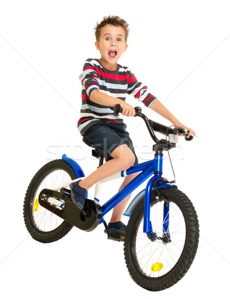 Stock photo: Excited little boy on bike