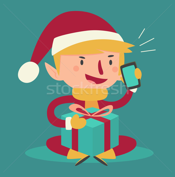 Stock photo: Cartoon Elf Talking on the Phone and Holding a Present
