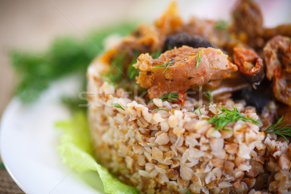 Stock photo: Boiled buckwheat with stewed chicken gizzards