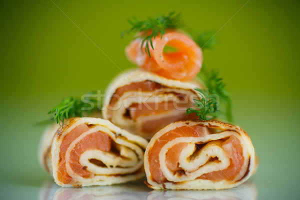  rolls of thin pancakes with salted red fish Stock photo © Peredniankina