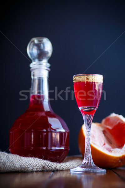 sweet grapefruit alcoholic cordial in the decanter with a glass Stock photo © Peredniankina