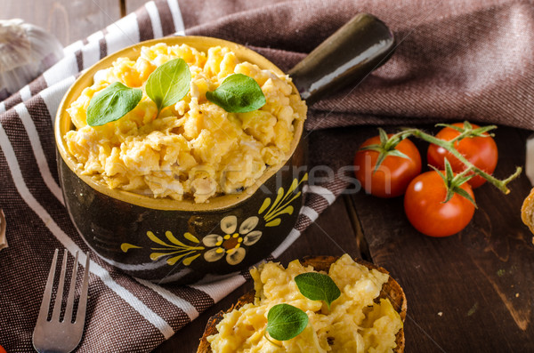 Scrambled eggs with herbs and garlic on toasted bread Stock photo © Peteer