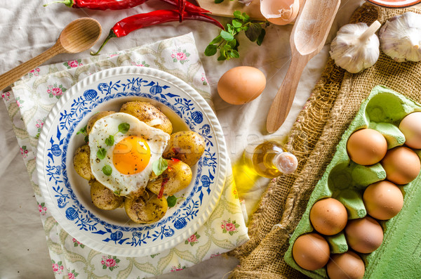 Baked potato with chili and fried egg Stock photo © Peteer