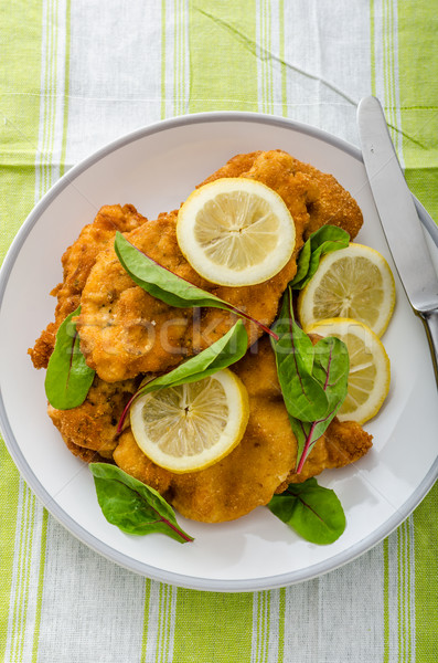 Fried schnitzel with herbs and lemon Stock photo © Peteer