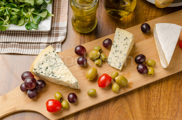 Delicious blue cheese with olives, grapes and salad Stock photo © Peteer