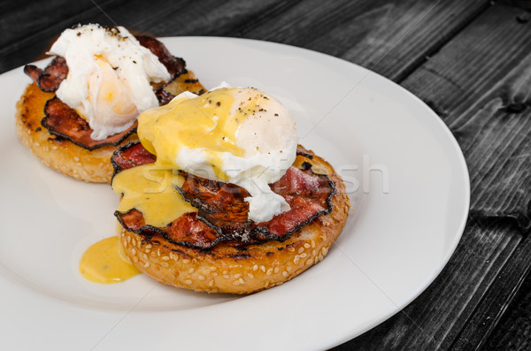 Benedict eggs with crispy bacon and hollandaise sauce on toasted Maffin Stock photo © Peteer