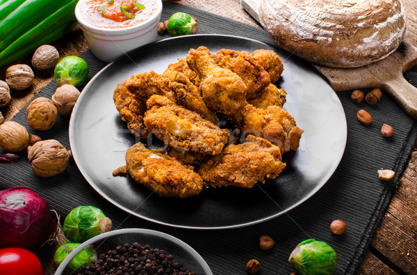 Spicy breaded chicken wings with homemade bread Stock photo © Peteer