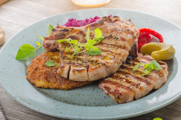 Grilled pork chops with herbs and garlic, potato pancakes Stock photo © Peteer