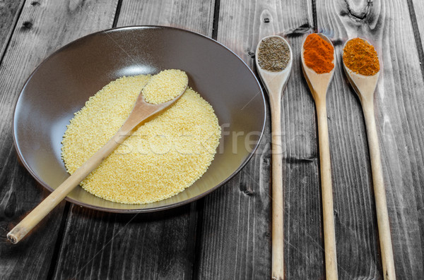 Spice on spoon with bowl of couscous Stock photo © Peteer