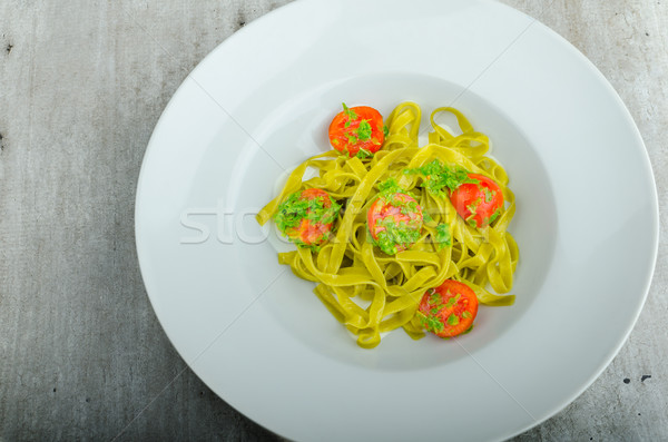 Pasta with basil pesto and pine nuts, cherry tomatoes Stock photo © Peteer