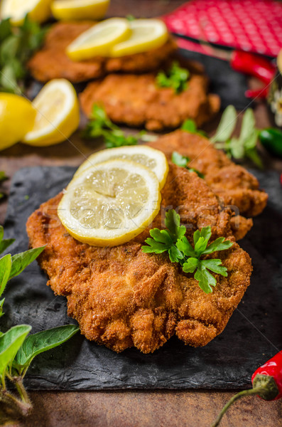 Stock photo: Schnitzel with fries, salad and herbs
