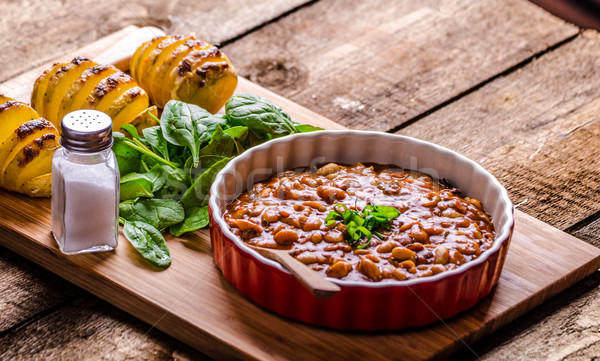 Spicy cowboy beans with hassleback potatoe with herbs Stock photo © Peteer