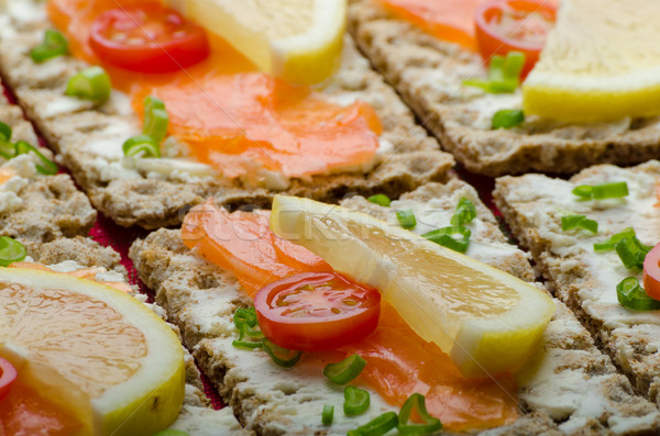 Bio healthy food - kneckebrot spread cheese with smoked salmon and cherry tomatoes Stock photo © Peteer