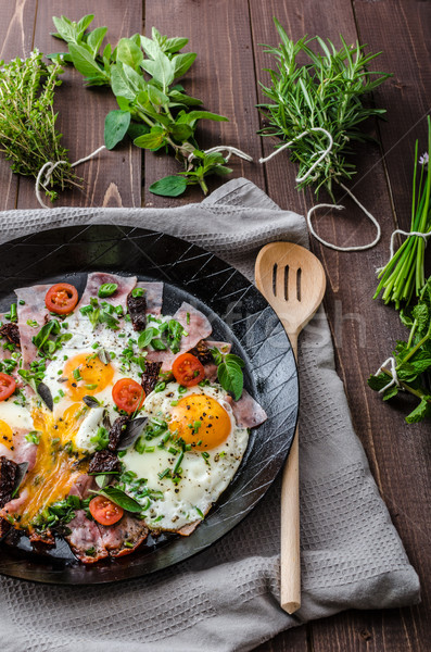 Fried eggs with ham and herbs Stock photo © Peteer