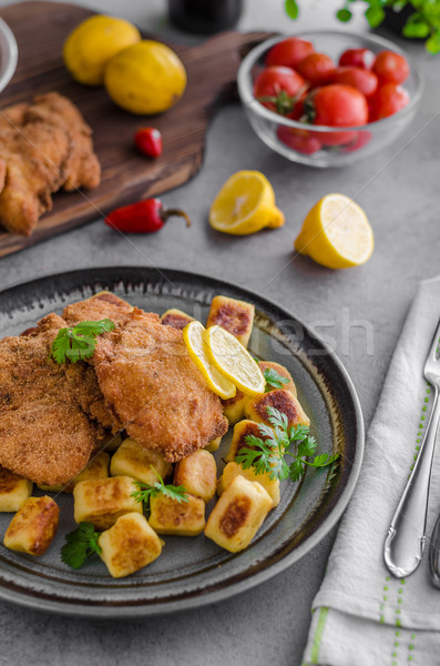 Schnitzel original with lemon and gnocchi fried Stock photo © Peteer