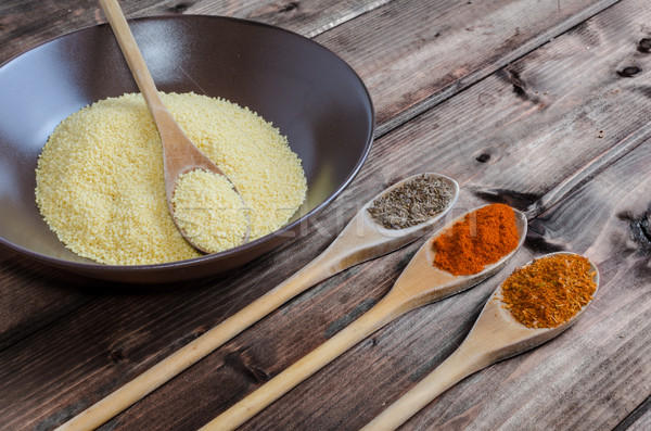 Spice on spoon with bowl of couscous Stock photo © Peteer