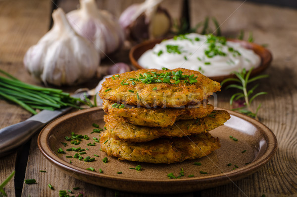 Potato pancakes with sour cream Stock photo © Peteer