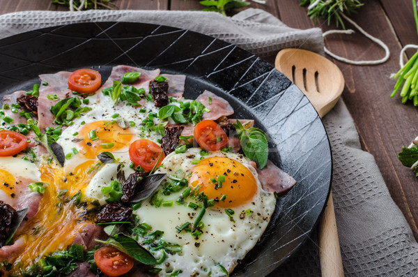 Fried eggs with ham and herbs Stock photo © Peteer