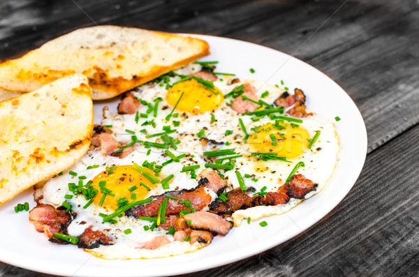 Stock photo: Bacon, eggs and chive with crispy toast