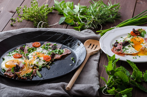 Fried eggs with ham and herbs Stock photo © Peteer