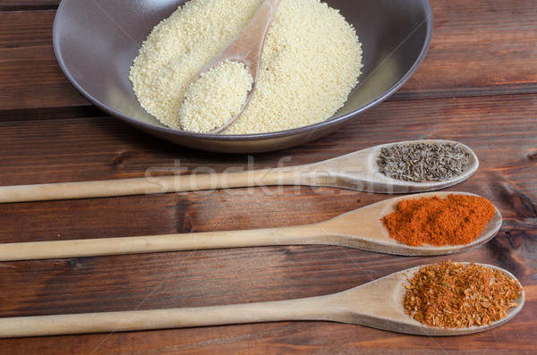 Spice on spoon with bowl of couscous Stock photo © Peteer