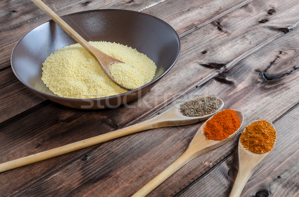 Spice on spoon with bowl of couscous Stock photo © Peteer