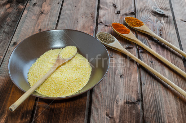 Spice on spoon with bowl of couscous Stock photo © Peteer