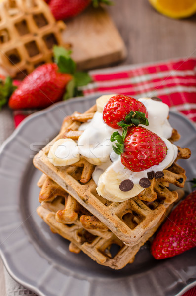 Belgian waffles with chocolate chips and fruits Stock photo © Peteer