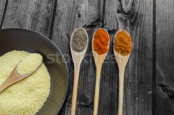 Spice on spoon with bowl of couscous Stock photo © Peteer