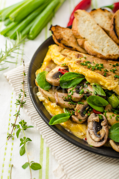 Omelet with mushrooms, lamb's lettuce, herbs and chilli Stock photo © Peteer