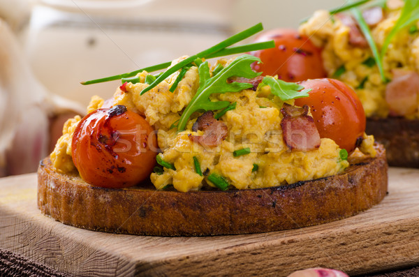Scrambled eggs witch bacon, herbs and tomato Stock photo © Peteer