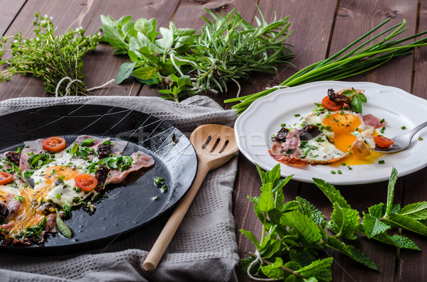 Fried eggs with ham and herbs Stock photo © Peteer