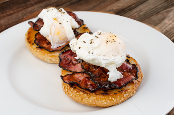 Benedict eggs with crispy bacon and hollandaise sauce on toasted Maffin Stock photo © Peteer