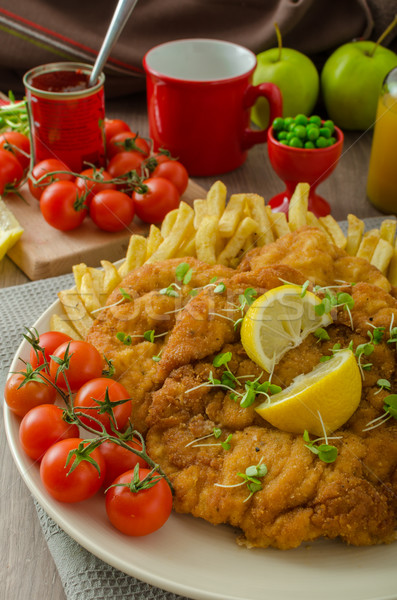 Stock photo: Schnitzel, french fries and microgreens salad