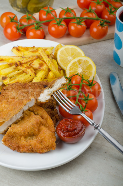 Stock photo: Big Chicken schnitzel with homemade chilli french fries