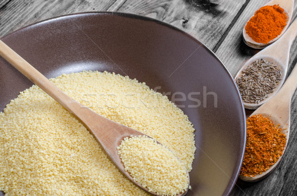 Spice on spoon with bowl of couscous Stock photo © Peteer