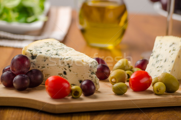 Delicious blue cheese with olives, grapes and salad Stock photo © Peteer