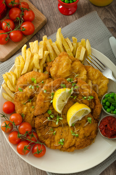 Schnitzel, french fries and microgreens salad Stock photo © Peteer
