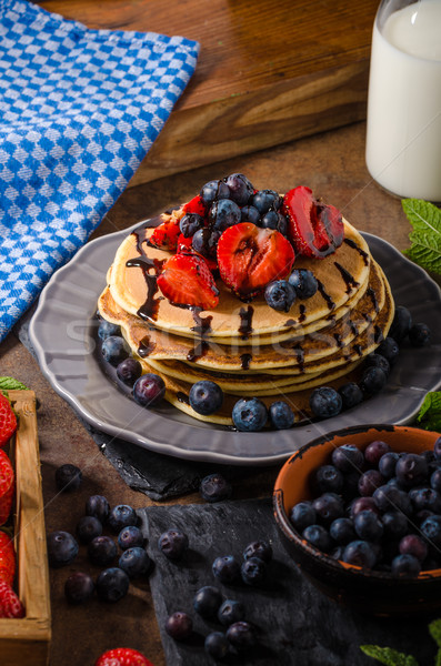 American pancakes with berries and chocolate Stock photo © Peteer