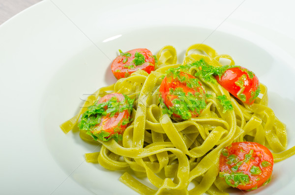 Pasta with basil pesto and pine nuts, cherry tomatoes Stock photo © Peteer