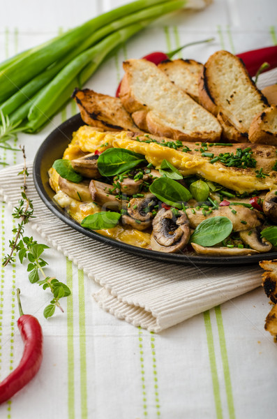 Omelet with mushrooms, lamb's lettuce, herbs and chilli Stock photo © Peteer