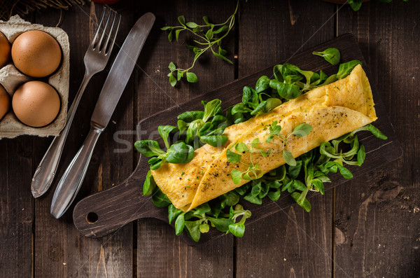 French omelet, fluffy, fresh eggs and herbs Stock photo © Peteer