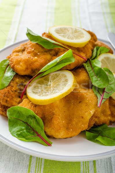 Fried schnitzel with herbs and lemon Stock photo © Peteer
