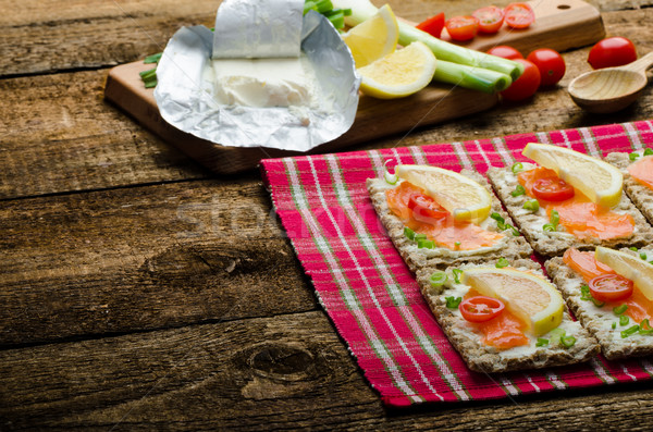 Bio healthy food - kneckebrot spread cheese with smoked salmon and cherry tomatoes Stock photo © Peteer