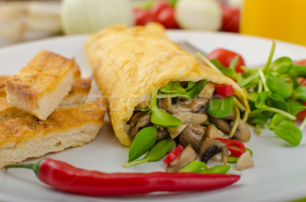 Omelette stuffed with mushrooms and microgreens Stock photo © Peteer