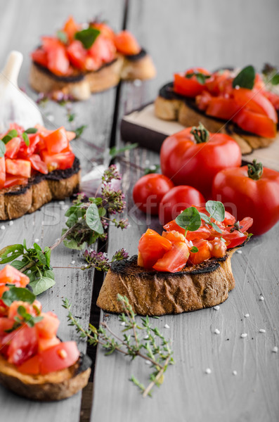 Bruschetta with tomatoes, garlic and herbs Stock photo © Peteer