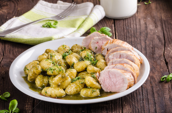 Pork tenderloin with herbs and spices, pesto gnocchi Stock photo © Peteer