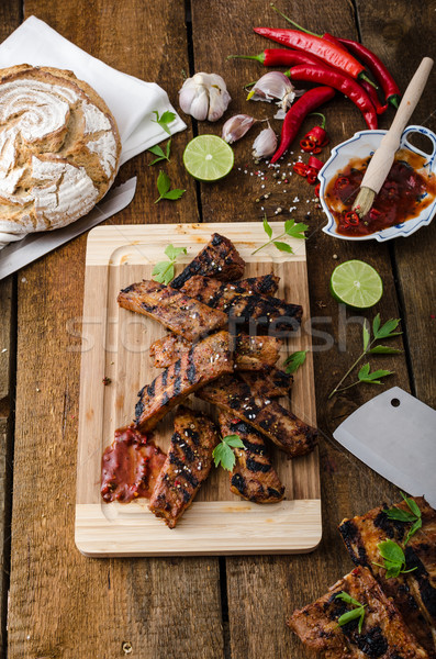 Grilled Spareribs in spicy marinade with beer and rustic bread Stock photo © Peteer
